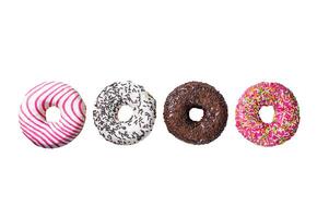 Assorted glazed donuts on a kitchen table. Isolated on white background. photo