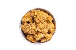 Crunchy chicken popcorn bites in a basket from fastfood. Isolated on white background photo