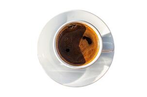 Cup of Turkish coffee in cafe. Isolated, white background. Top view. photo