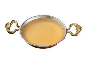 Clear broth stock without meat in cooking skillet. Isolated on white background. Top view. photo