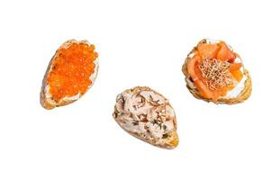 Bruschetta with Hot Smoked salmon, red caviar and herbs. Isolated on white background. photo