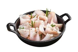 Fresh sliced lard with salt, garlic and pepper in pan with herbs. Isolated on white background. Top view. photo