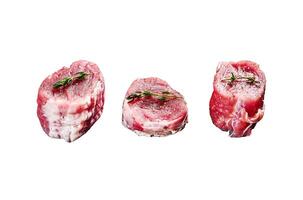 Raw pork medallion steaks with pepper and thyme. Isolated on white background. Top view. photo