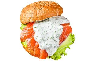 Sandwich with salted fish salmon, avocado, burger bun, mustard sauce and Iceberg salad. Isolated on white background, Top view. photo
