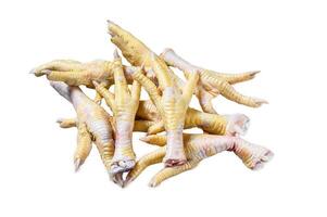 Raw Chicken feets on kitchen table. Isolated on white background, top view. photo