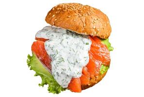 Sandwich with salted fish salmon, avocado, burger bun, mustard sauce and Iceberg salad. Isolated on white background. photo