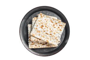 Pieces of matzah in a vintage steel tray. Isolated on white background. photo
