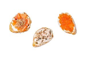Bruschetta with Hot Smoked salmon, red caviar and herbs. Isolated on white background, top view. photo