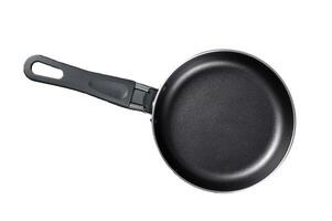 Empty iron frying pan on rustic table. Isolated, white background. photo