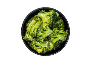 Green boiled broccoli cabbage in pan. Isolated, white background. Top view. photo