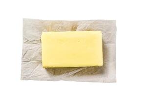 Butter on craft paper, dairy farm products. Isolated on white background. Top view. photo
