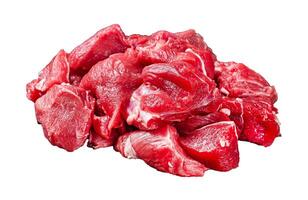 Raw diced red beef meat for Goulash on marble board. Isolated, white background. photo
