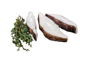 Atlantic halibut fish, raw steaks on wooden board with herbs. Isolated on white background. photo