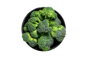 Raw green broccoli cabbage in a colander. Isolated, white background. photo