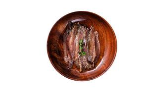 Canned Anchovies fish fillet in a wooden bowl. High quality Isolate, white background. photo