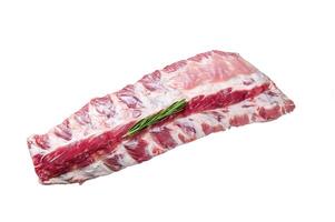 Fresh Raw pork rack spare ribs with spices on a cutting board with knife. Isolated on white background photo