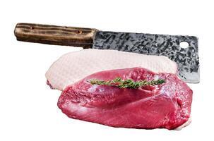 Fresh Raw Duck breast fillet steaks on butcher board with meat cleaver. Isolated, white background. photo