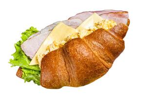 Breakfast croissant sandwich with scrambled eggs, cheese and ham. Isolated, white background. photo