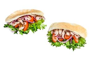 Doner kebab with grilled chicken meat and vegetables in pita bread. Isolated on white background. photo
