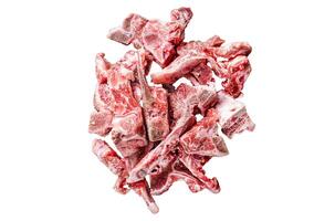 Raw meat on the bone diced for stew. Isolated, white background. photo