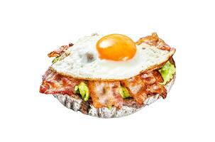 Open sandwich with avocado, fried bacon and egg. Isolated on white background. Top view. photo