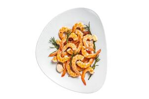 Fried Prawns Shrimps in a plate with herb and garlic. Isolated on white background. photo