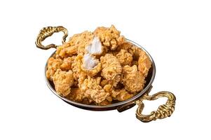 Homemade Crispy Popcorn Chicken bites in a skillet Isolated on white background. photo