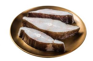 Sliced halibut fish, raw steaks on plate with thyme. Isolated on white background. Top view. photo