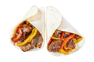 Fajitas Tortilla wrap with beef meat stripes, colored bell pepper and onions and salsa. Isolated on white background, Top view. photo