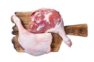 Uncooked Raw duck legs, Poultry meat on a wooden board. Isolated, white background. photo