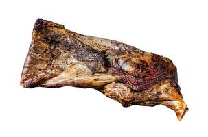 Grilled lamb or goat shoulder meat on a wooden board with knife and meat fork. Isolated on white background, top view. photo