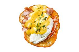 Brioche sandwich with bacon, egg Benedict and hollandaise sauce. Isolated on white background. Top view. photo