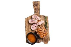 Sliced Duck breast fiilet, roasted steak with sauce. Isolated on white background, top view. photo