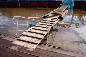 A wellcrafted wooden dock with sturdy stairs leads to calm waters, perfect for enjoying peaceful moments at the serene lake or engaging in leisure activities with friends and family photo