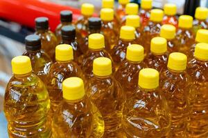 Plastic bottles with yellow caps are stacked on each other photo