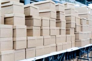 A large warehouse that is filled with numerous cardboard boxes photo