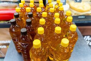 Plastic bottles with yellow caps arranged neatly on a table photo