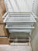 This beautifully designed family home features a spacious closet with shelves for organization and practical wall baskets for effective storage, ensuring easy access to essentials photo