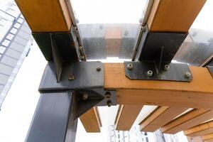 A detailed close up view of a unique wooden structure with a sturdy metal frame photo