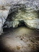 The entrance to a mysterious cave reveals stunning natural rock formations, where shadows play and adventure calls for exploration photo