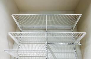 This very spacious closet features welldesigned shelves and a sturdy, durable hanging rack, providing ample storage space and efficient organization for all your belongings and items photo