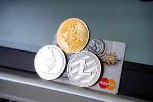 Bitcoin, litecoin, and ether on a credit card photo