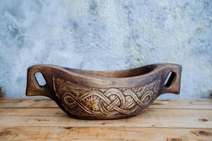 A wooden bowl with a celtic design on it photo