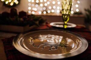 A plate with a deer design on it sits on a table photo