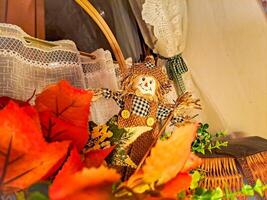 autumn composition with a small scarecrow standing on the window photo