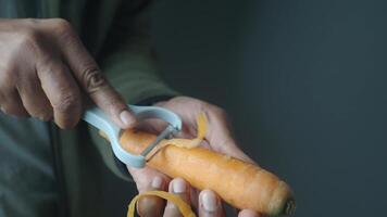 Carefully peeling a fresh and vibrant carrot using an efficient vegetable peeler tool video