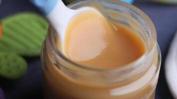 baby food in a container on table with copy space. video