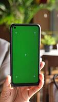 Smartphone with a green screen background ideal for editing video