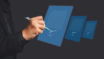 A businessman using a pen signing electronic documents on digital documents on a virtual screen photo