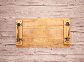 Top view of an empty wooden tray on a wooden table photo